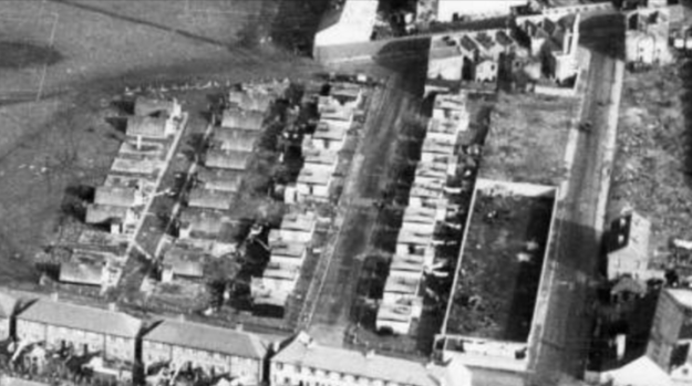 1954 aerial view of Queens Road and its temporary housing, looking east. This is a clip from Merton Memories photo 49278, and is copyright London Borough of Merton.